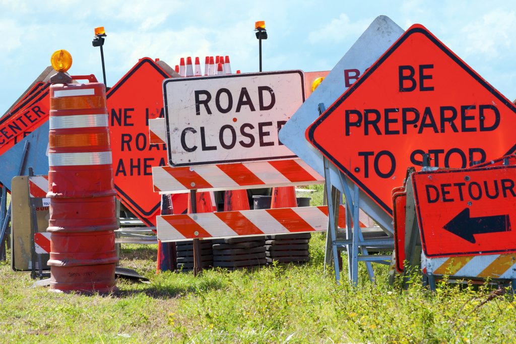 Highway traffic signs illustrating DOT English Language Proficiency requirements for commercial drivers